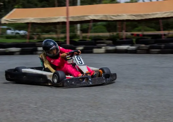 A young guest racing a go-kart on the estate track